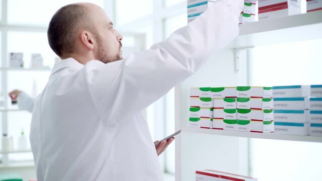 pharmacist using a smartphone while checking the product.