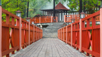 Fototapeta premium red bridge over the hot water lake