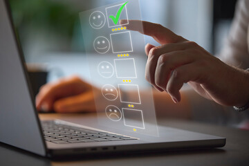 Man Using Laptop With Graphic Overlay To Leave Positive 5 Star Online Review