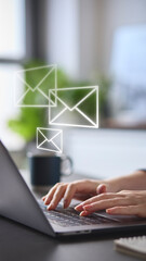 Email Concept With Woman Using Laptop With Graphic Overlay Of Envelopes