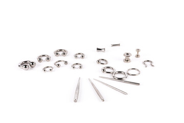 multiple different body piercings and tapers on white background