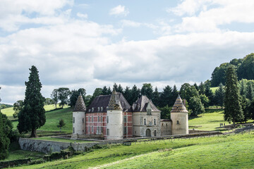 Fototapeta na wymiar old, medieval castle with many towers in the French region of the Morvan in summer 