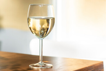 Glass of white wine placed on a bar in a pub, alcohol drinking and night out concept