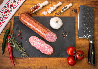 ordinary organized table to be served. Food tray with scrumptious portions of cold cuts, tomatoes...