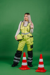 Engineer girl wearing wearing talks on the walkie talkie. Green screen