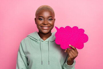 Photo of good mood girl hold sparkling speech bubble talking with friend isolated on pink color background