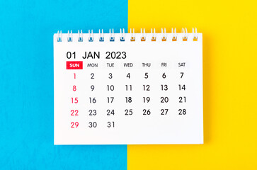 The January 2023 Monthly desk calendar for 2023 year on blue and yellow background.