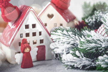 New Year holiday card. Christmas. Two houses wrapped in white scarf with Christmas tree branches in...