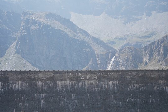 Lettering on the wall of Serru Lake dam: Citta di Torino AEM. Gran Paradiso National Park, Italy.