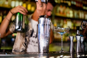 man bartender making cocktail in bar