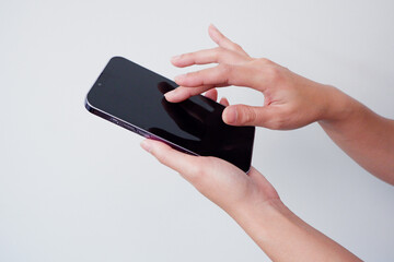 girl holding a smartphone touching the screen.