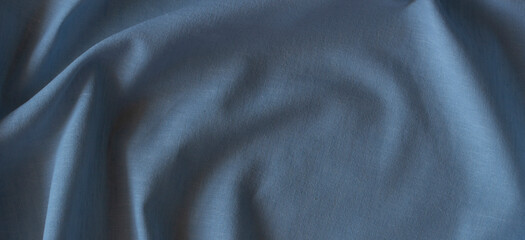 Abstract crumpled linen fabric texture background. Natural blue color dyed linen organic eco...