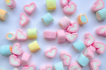 Colorful marshmallows on a white background. Pastel colored marshmallow candies pattern on white background.  Valentine's day concept. Life is sweet marshmallows concept.