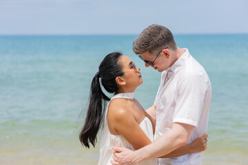 Romatic couple passionately kissing on dock. Beautifull wedding couple kissing and embracing on the beach.