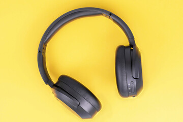 Full-size headphones on a yellow background