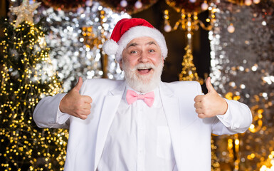 Be happy. happy mature man white formal suit. successful businessman in event tuxedo. senior man santa christmas light illuminated background. bright and festive xmas mood. new year party
