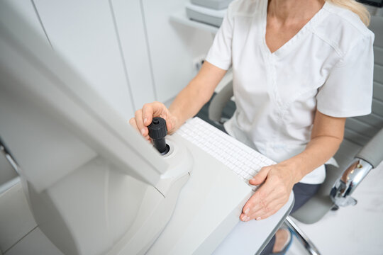 Ophthalmologist is working with autorefractometer in hospital