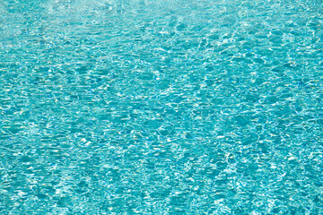 summer blue swimming pool water background with ripples