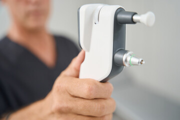 Close up photo of medical worker holding tonometer