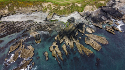 Rocks on the Irish littoral, top view. The coast of the Atlantic Ocean. Nature of Northern Europe. Rocky coastline. Drone photo.