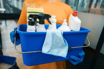 Employeecleaning service holds bucket in her hands with professional set © Viacheslav Yakobchuk