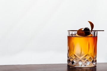 old fashioned cocktail on a wooden table and white background