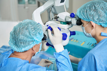 Close up photo of doctors doing eye microsurgery