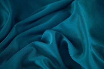 A crumpled teal fabric background