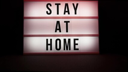stay at home, a warning sign and police flashing on the led sign on a black background - Powered by Adobe