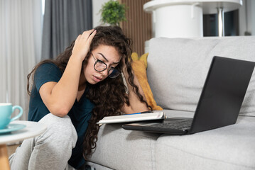 Young sick nervous schoolgirl or student is trying to study remotely from home for exam but can't...