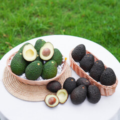 Whole and cut avocados on table. Space for text