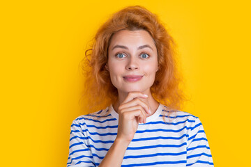 dreamy redhead girl face isolated on yellow background. face of young redhead girl in studio.