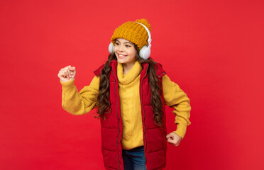 kid wear warm clothes and dancing. express positive emotion. winter fashion.