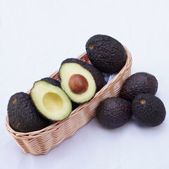 Whole and cut avocados on white background