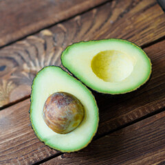 food background with fresh organic avocado on old wooden table, top view