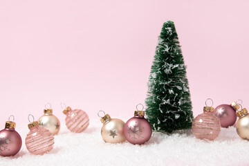 Pink holiday background. Christmas tree and ornaments. 