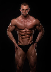 Fototapeta na wymiar Muscled male model posing in studio