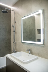 Bathroom interior with mirror and wash basin.