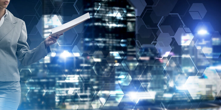 Close of businesswoman against night cityscape background and technology concept