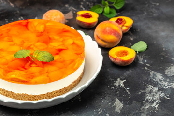 cheesecake with peaches, peache jelly, jam on a dark background. banner, menu, recipe place for text, top view