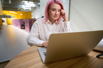 Serious woman working in the office online