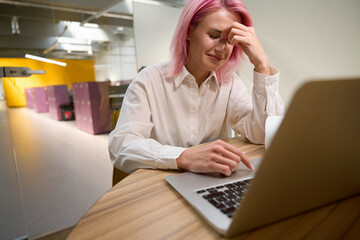 Woman getting frustrated while working in office