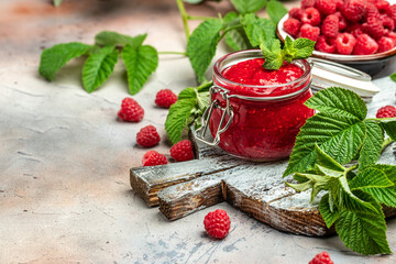 Raspberry jam with berry on light background. Homemade jam with raspberry. banner, menu, recipe place for text, top view
