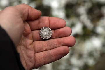 Old Moroccan coin in hand