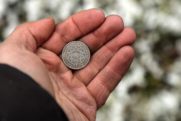 Old Moroccan coin in hand