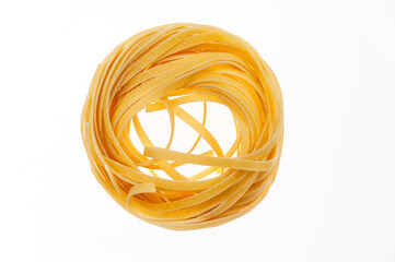 Nests of raw pasta on a white background.