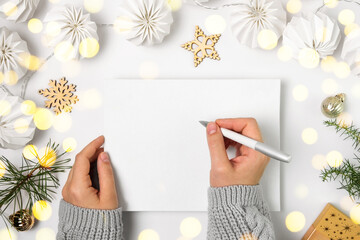 Woman Writing in Empty Notebook on White Desk. Girl Hands with Pen Among Gift Box and Winter...