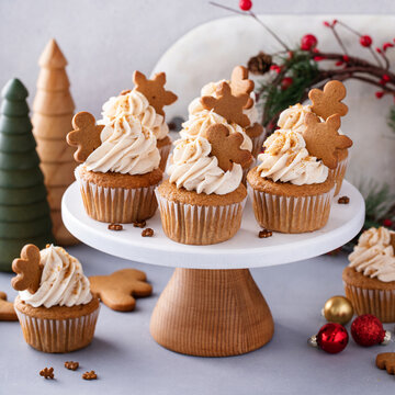 Gingerbread cupcakes with cream cheese frosting topped with gingerbread cookies