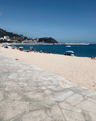 Blanes beach on the Costa Brava. Turquoise crystalline waters of the Mediterranean Sea. Costa brava tourist beaches. Catalonia, Spain.