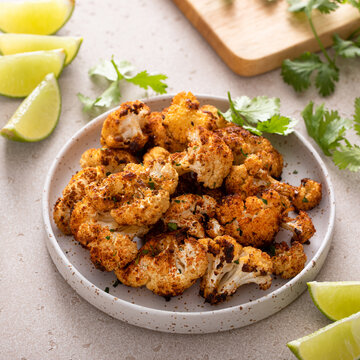 Spicy roasted cauliflower served with lime and cilantro